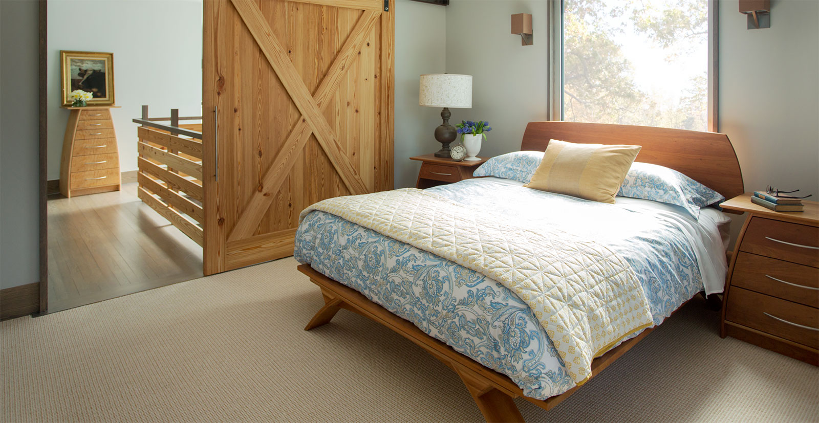 bed in modern bedroom with sliding barn door
