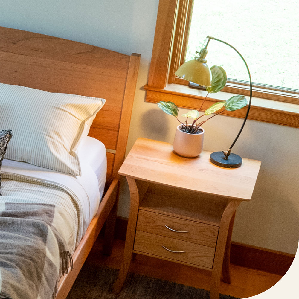 lamp with yellow shade on a nightstand