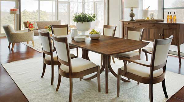 elegant dark wood dining set with cream colored upholstered chairs