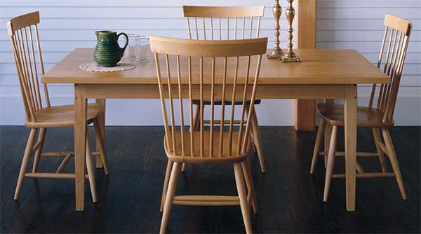 simple 4 leg table with 4 chairs on a porch