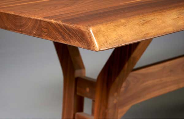 close up of the live edge of a walnut dining table