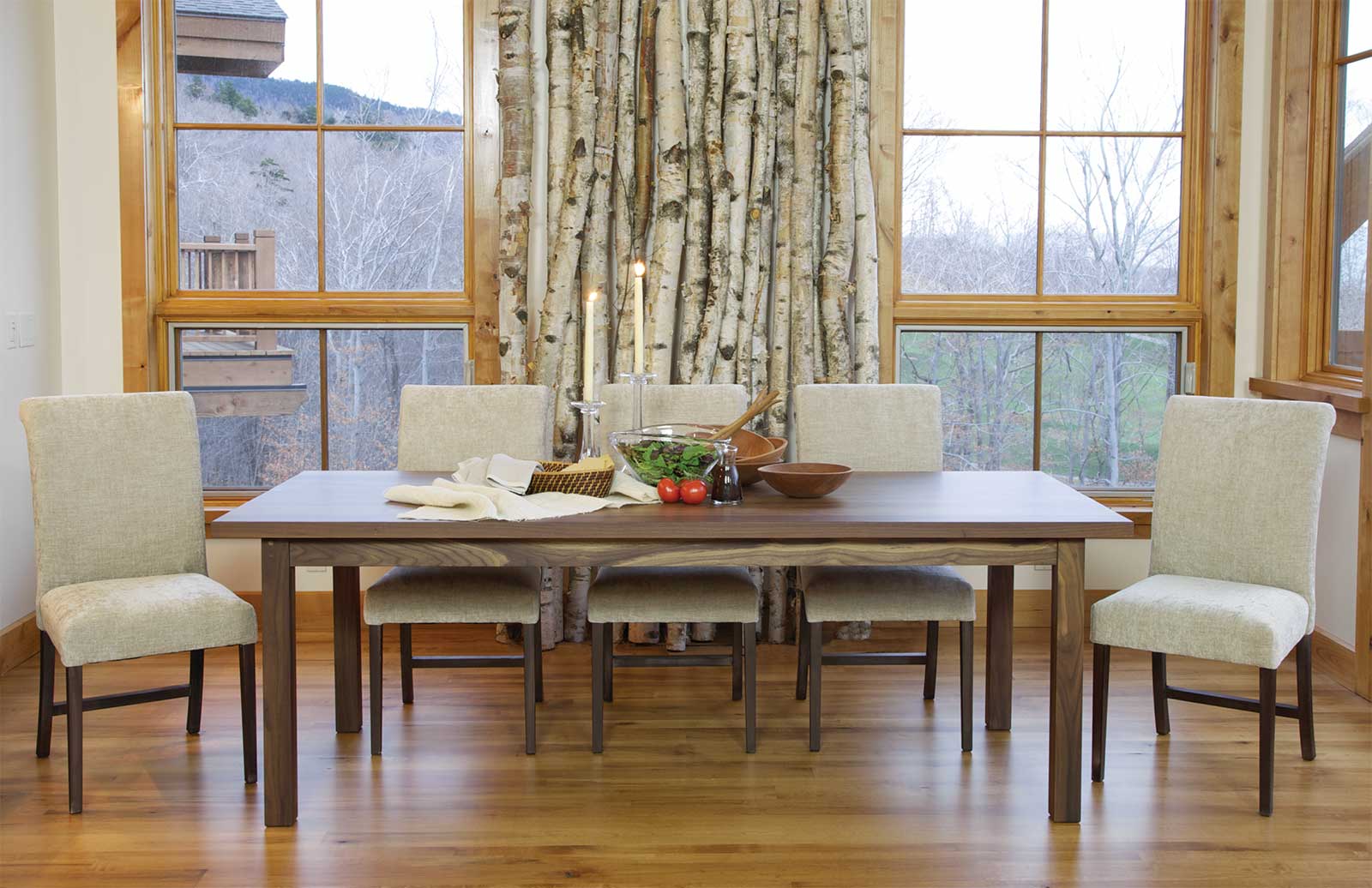 walnut dining table and chairs. Set for dinner.