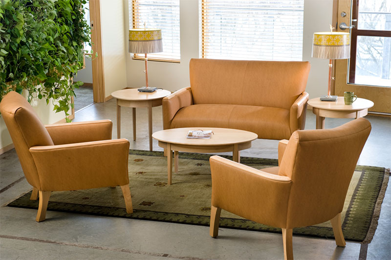 a modern loveseat and matching chairs in a hotel lobby