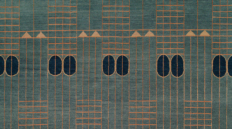 close up of cool geometric rugs in greens, blues and golds