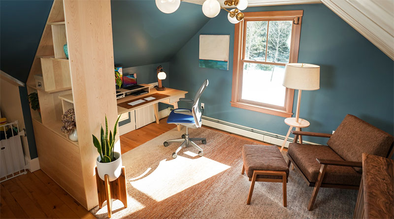 attic home office with teal with reading chair and floor lamp