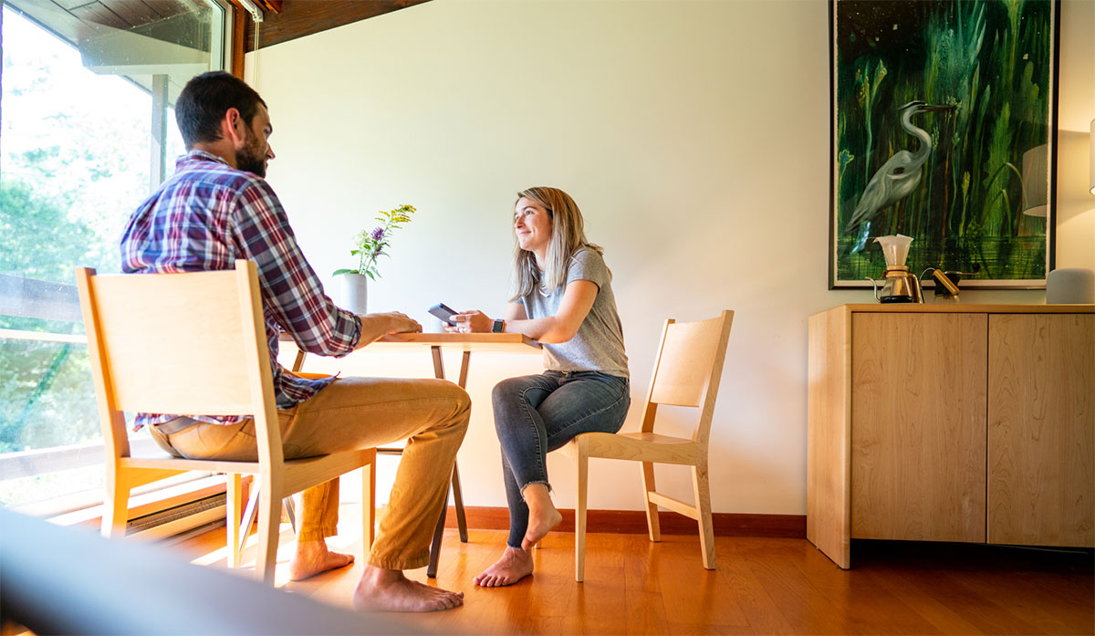 a couple sitting at small table in modern rooom