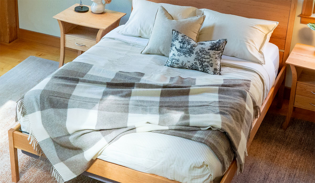 overhead view of bed with plaid throw