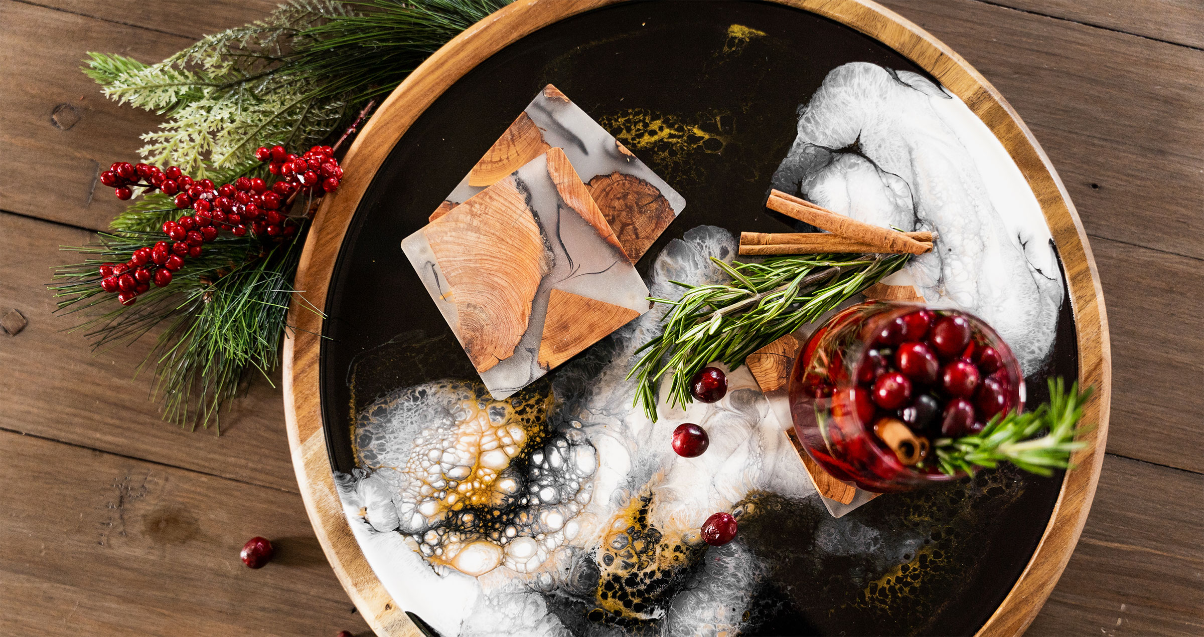 a wood and resin lazy susan with appetizers and christmas decorations
