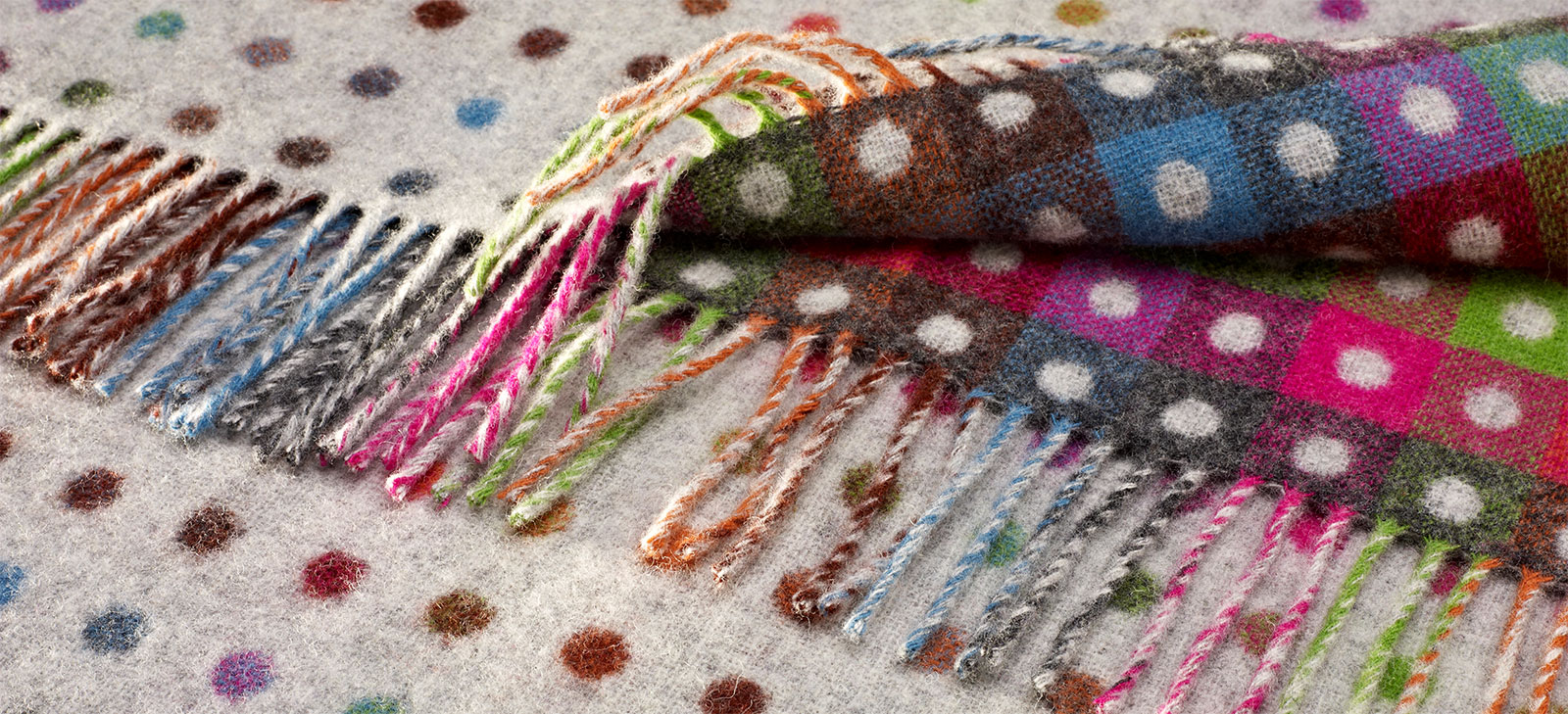 beige and multicolor spots on a wool throw