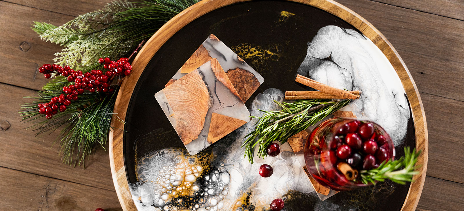 a wood and resin lazy susan with appetizers and christmas decorations