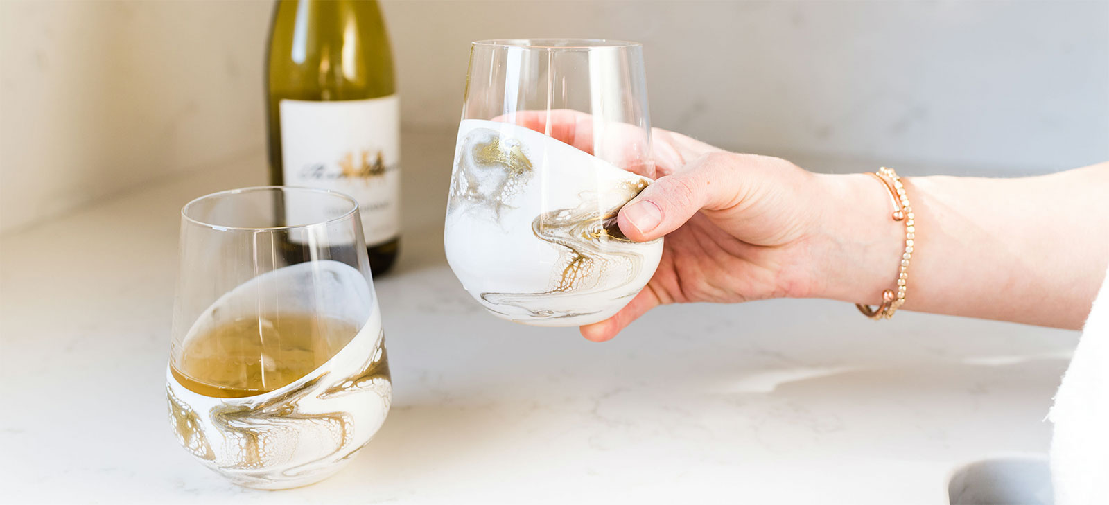2 cocktail glasses with white  and gold resin accents