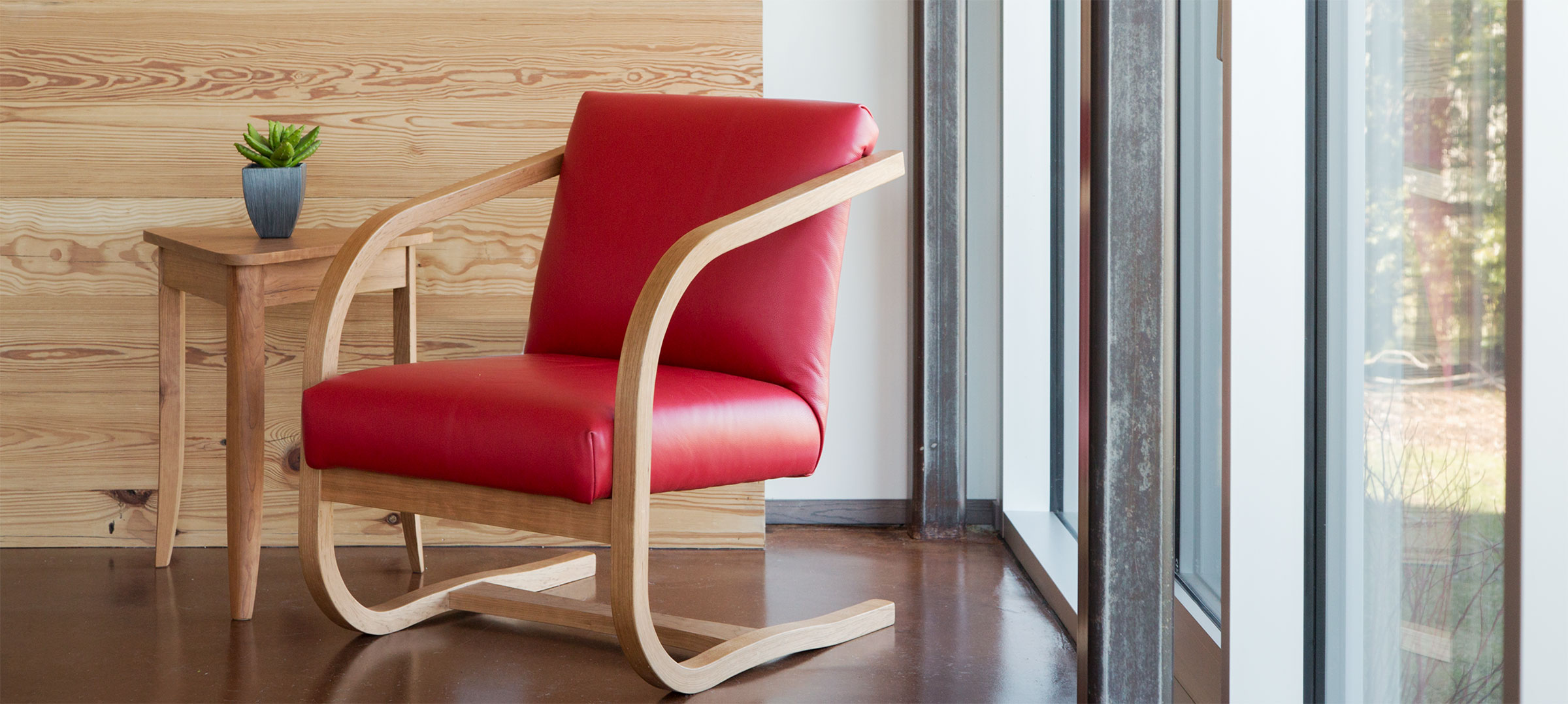 this belmont chair is a modern chair with red leather and wood frame
