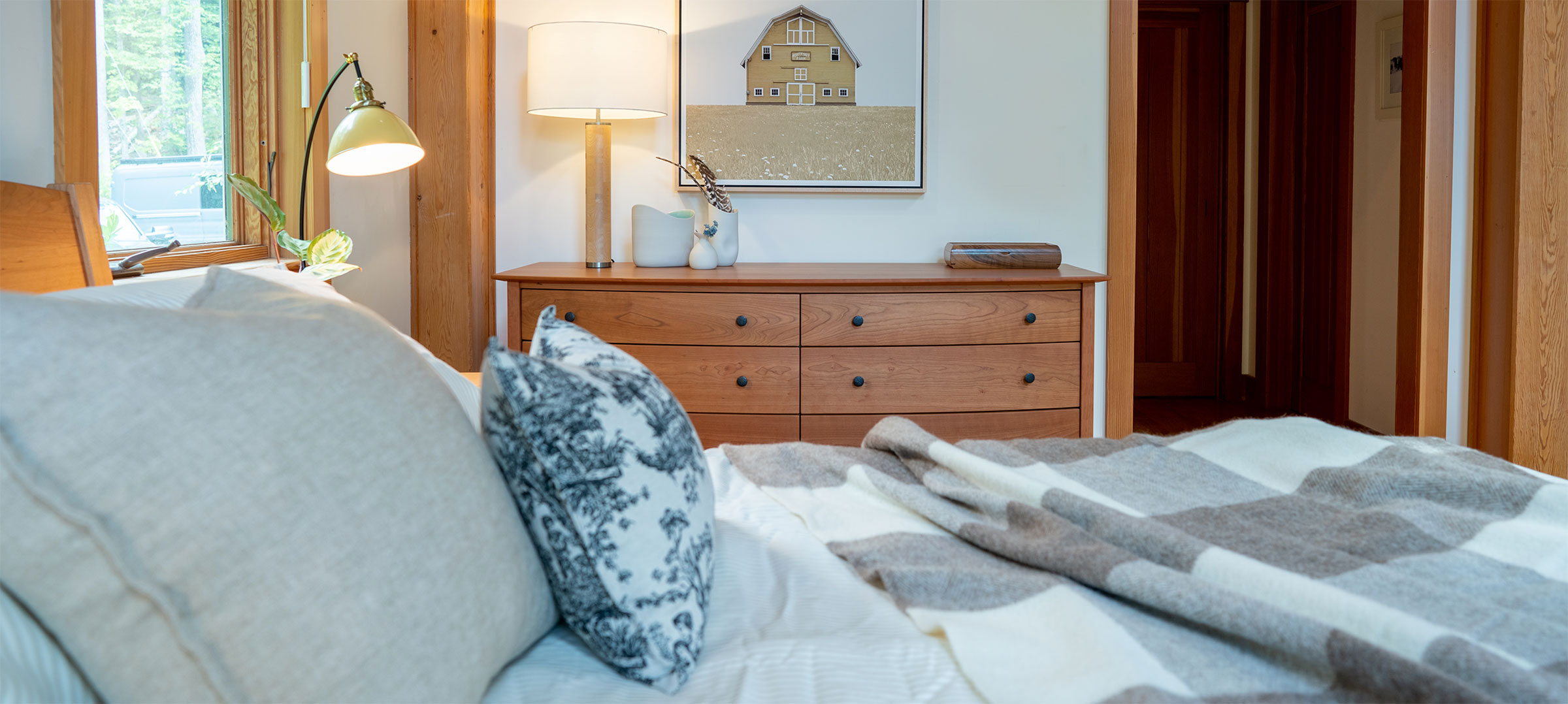 cozy bedroom with 8 drawer cherry chelsea bedroom in the background