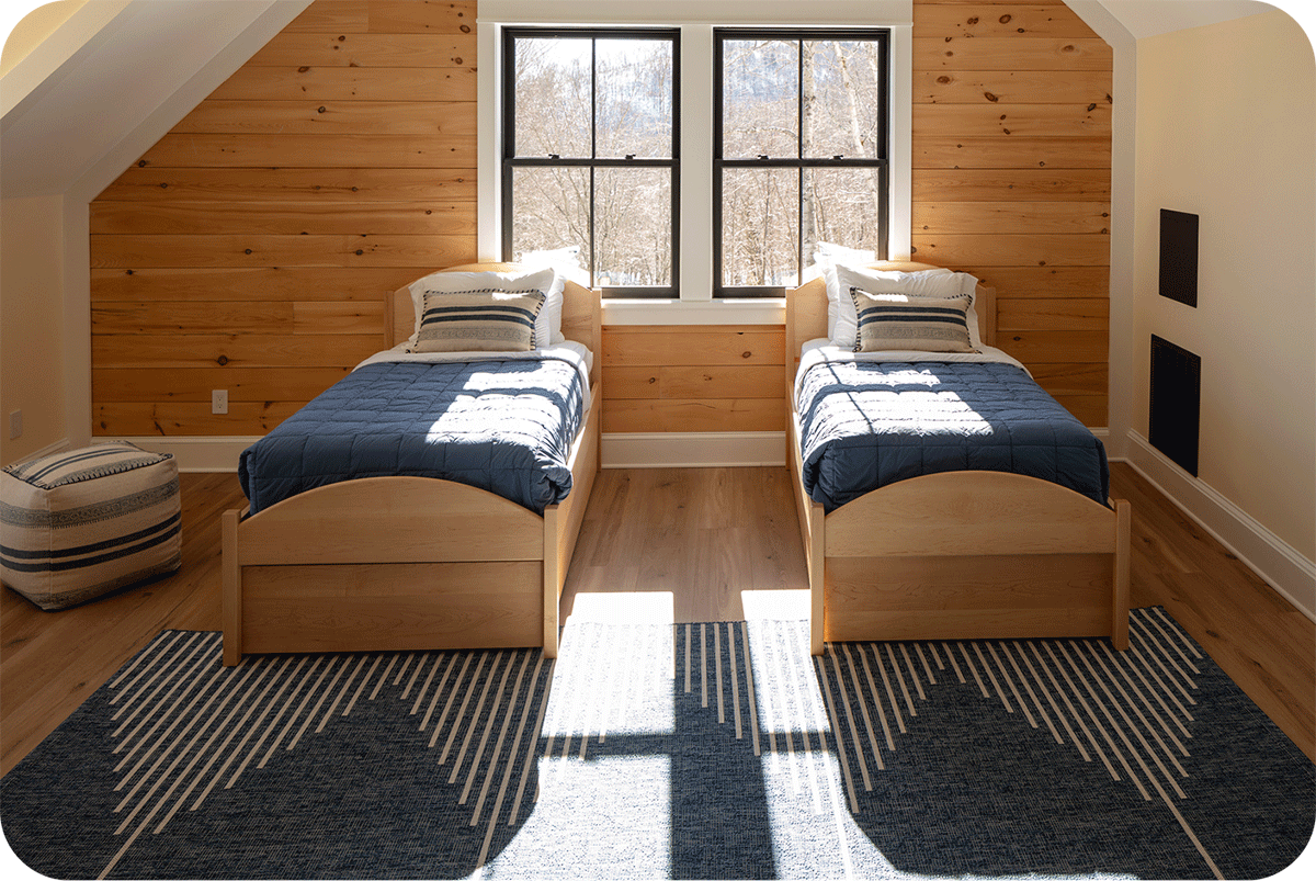 an attic bedroom with 2 twin beds side by side