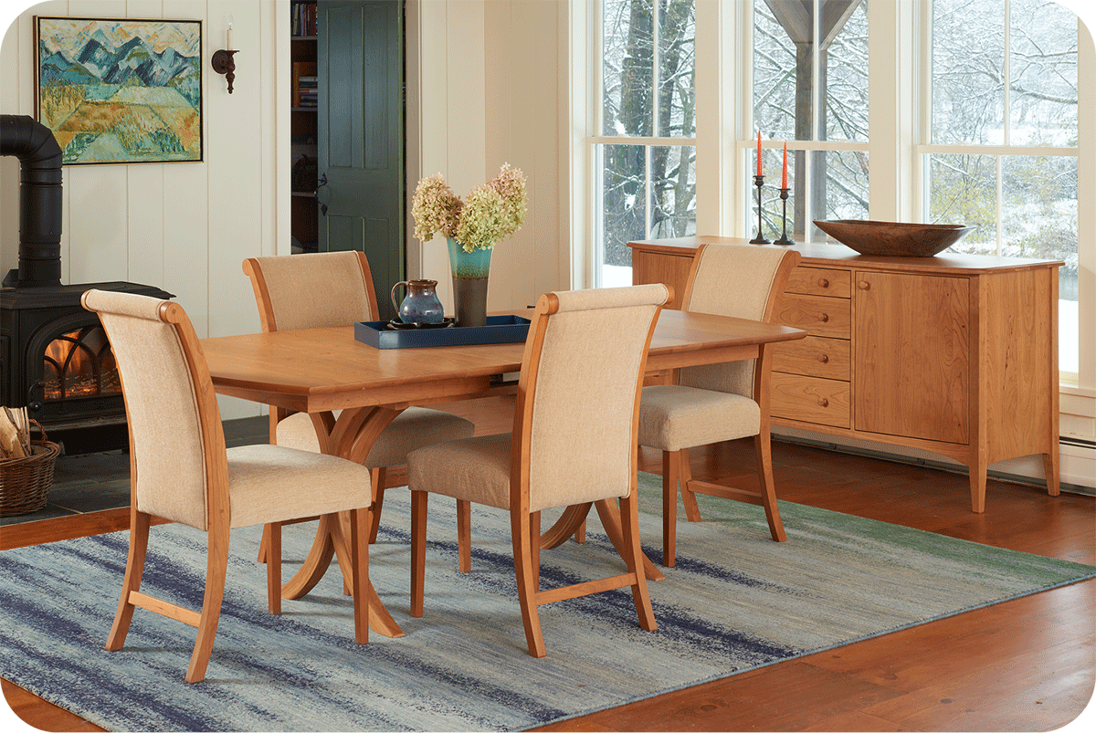 cherry dining set with buffet in a farmhouse type dining room with a woodstove