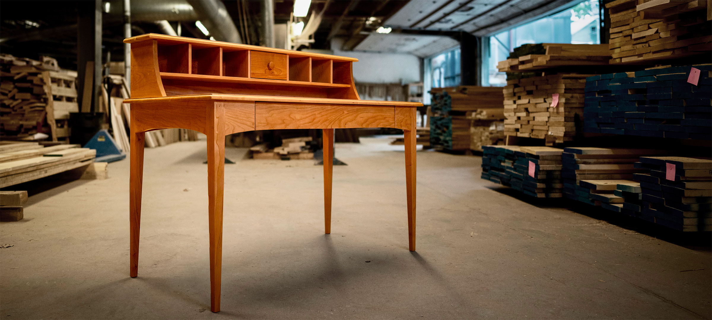 a cherry writing desk in the workshop