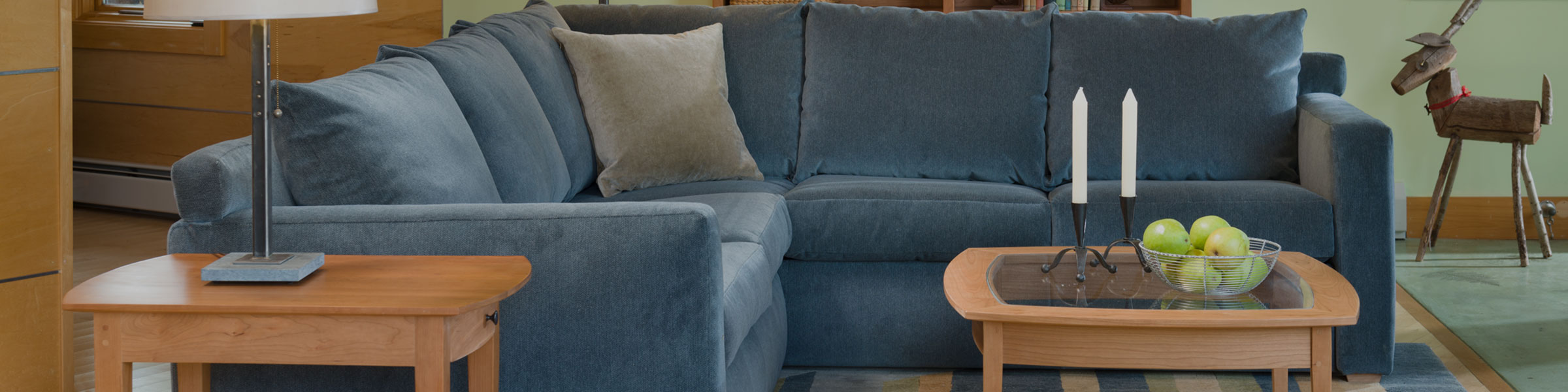 close up of a blue sectional with cherry coffee and end table