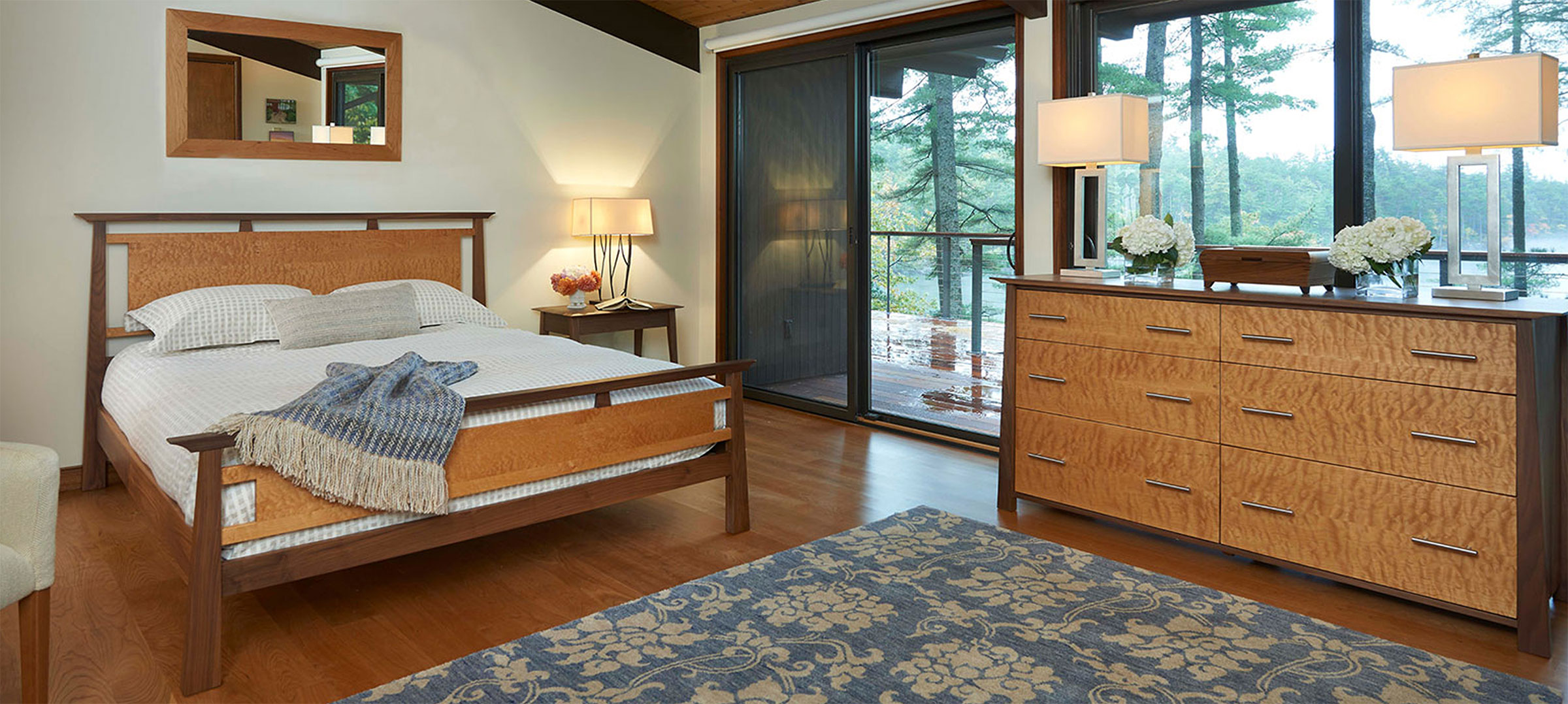 two tone bed and dresser in room with glass wall