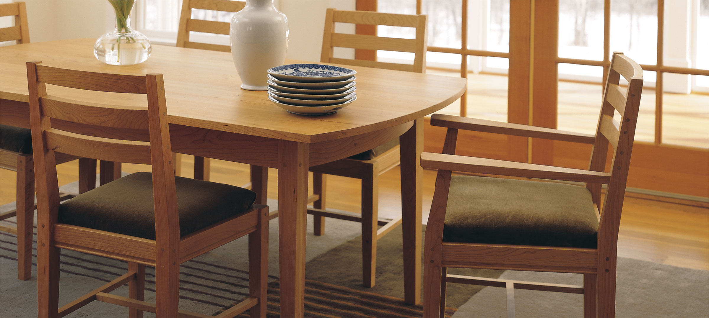 cozy dining room with moss green upholstered wood chairs