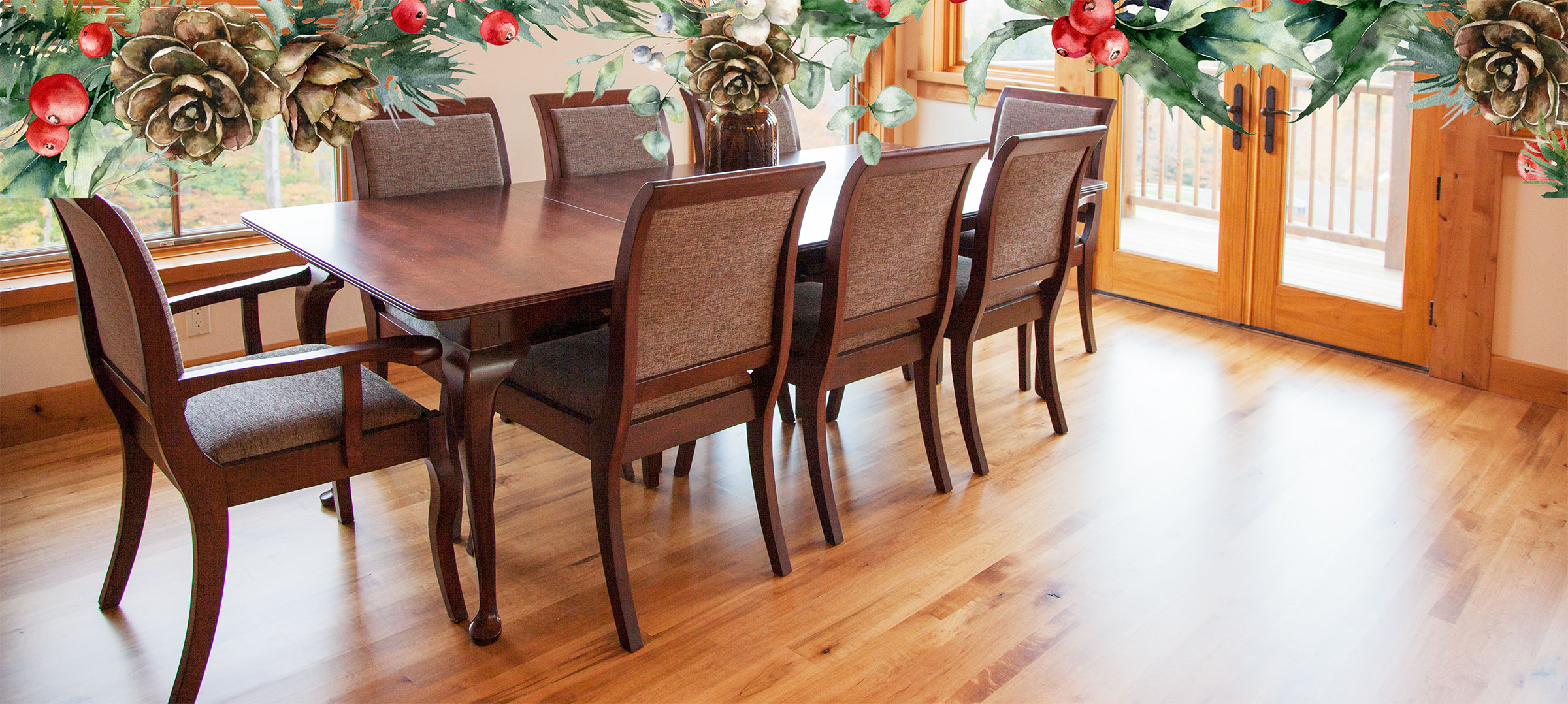 A walnut 4 leg dining table with 4 beige upholstered chairs. There are candles on the table.