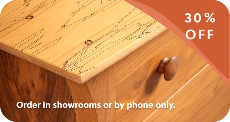 close up of exotic wood nightstand top with 30% off banner