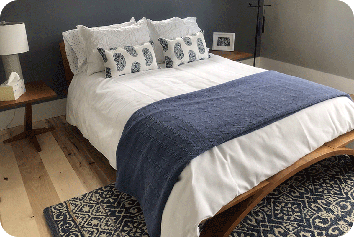 Vernon bedroom set in front of a big wall of windows and a door