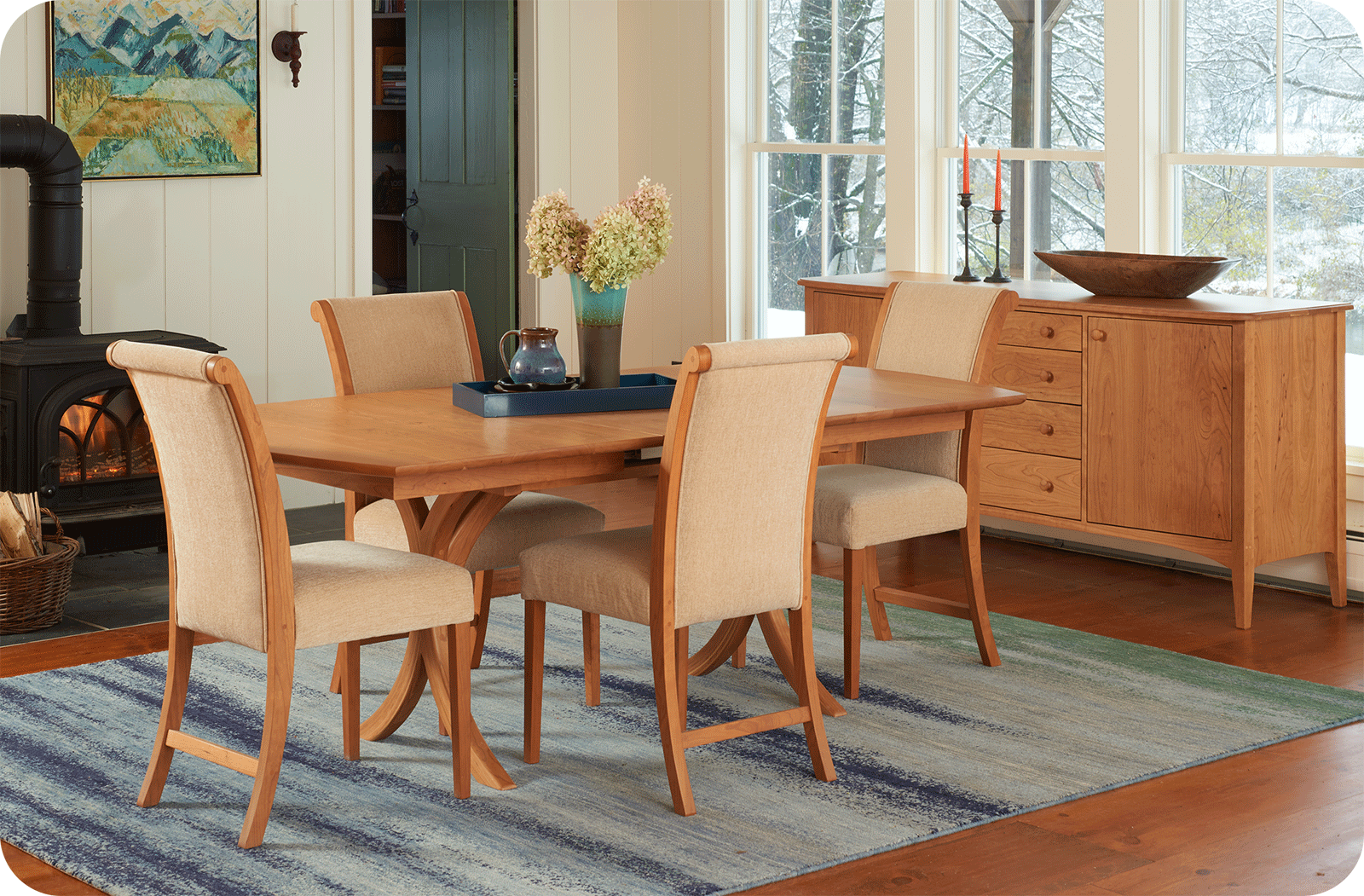 cherry dining set in room with wood stove