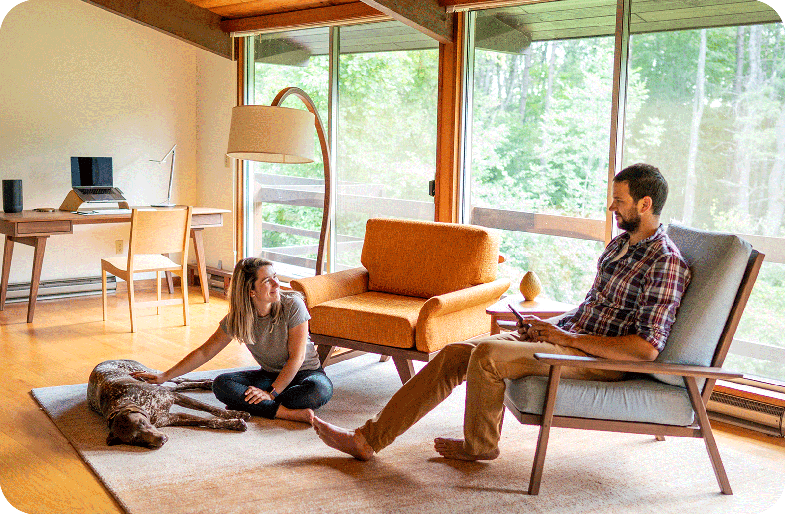 couple hanging out with their dog on the floor, modern house