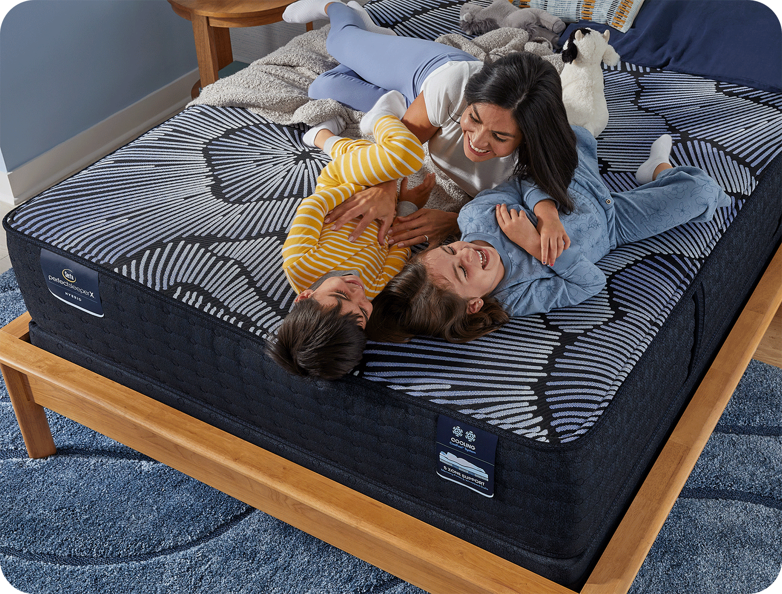mom playing on the bed with her kids
