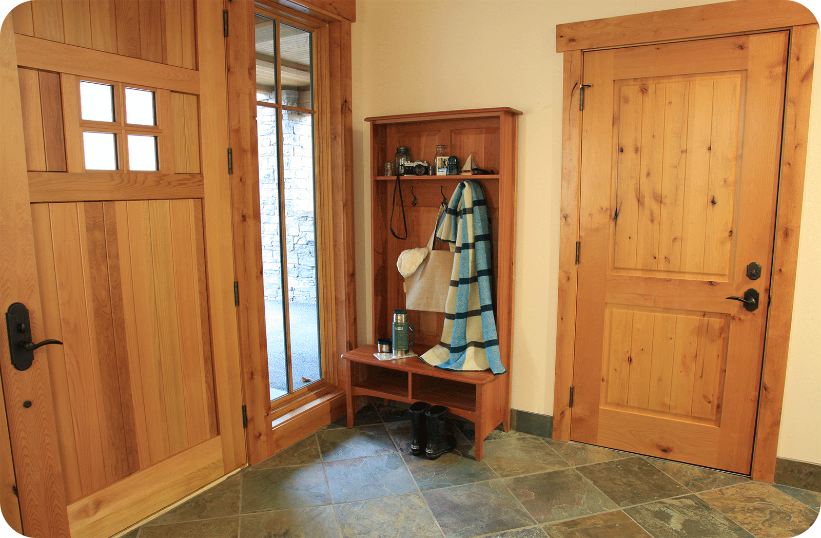 entry way with hall tree with shawl, wicker basket and water bottle