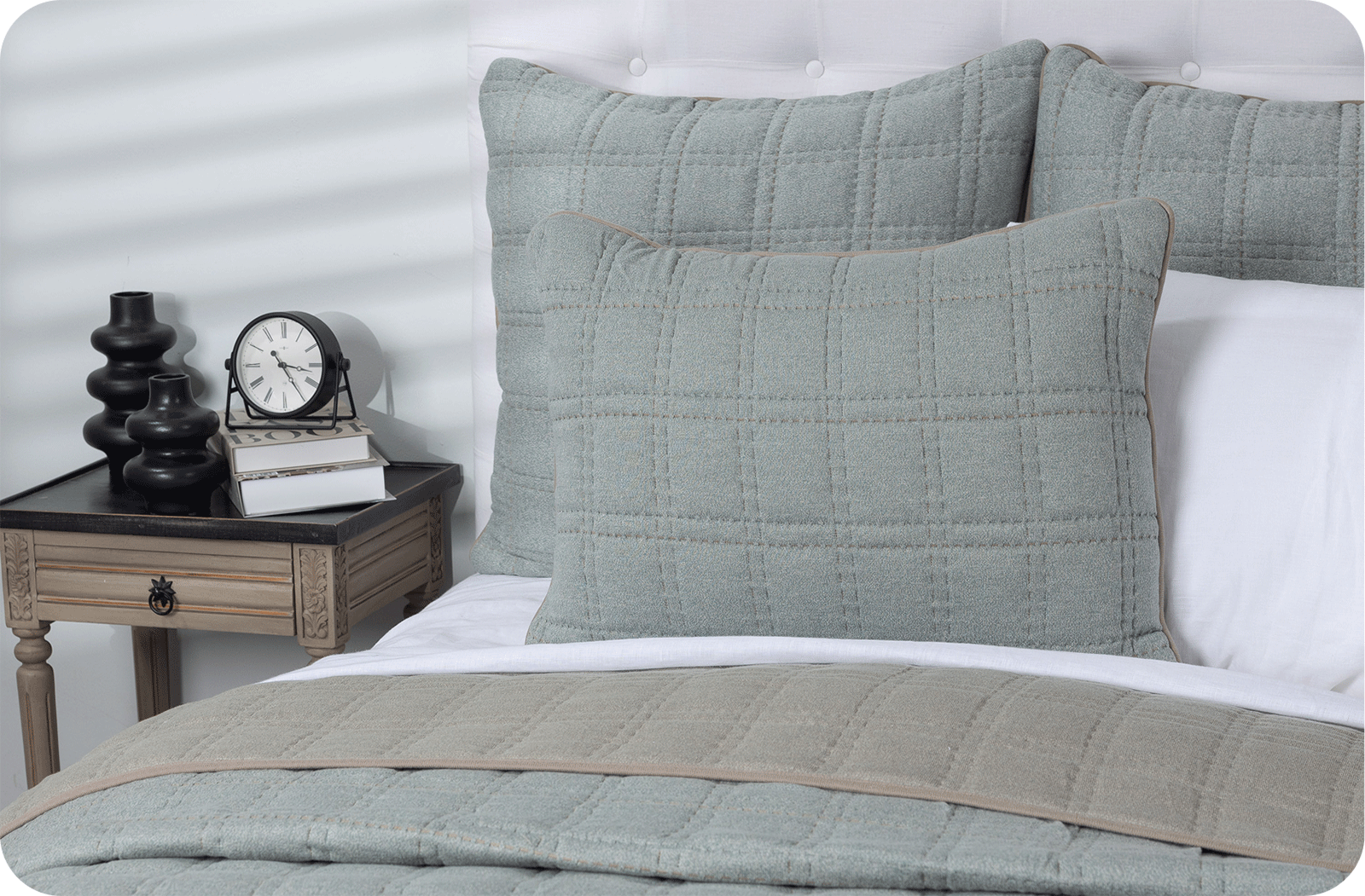 calm bluish grey quilt on a bed