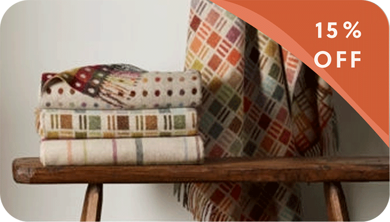 colorful throws on a wooden bench