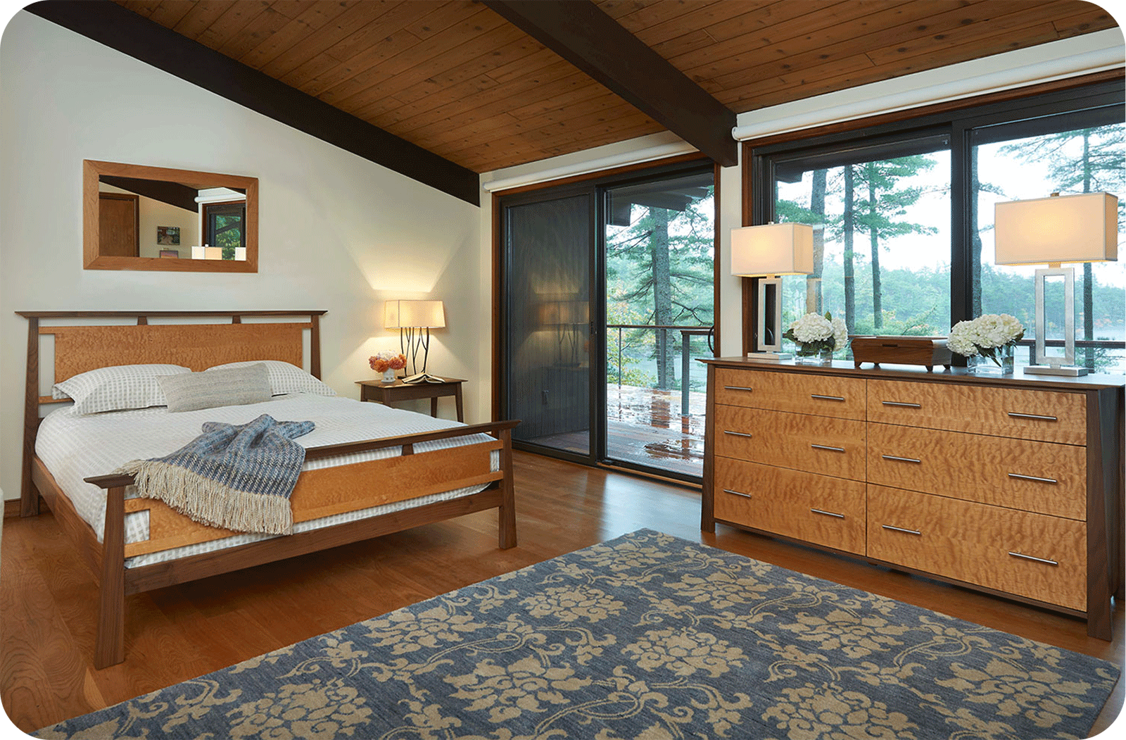 two tone wood bed and dresser in room with glass wall