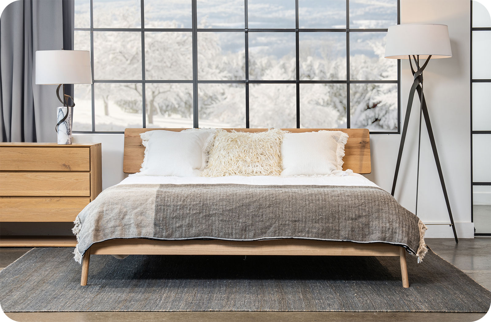 a modern bedroom with forged steel table lamp and floor lamp