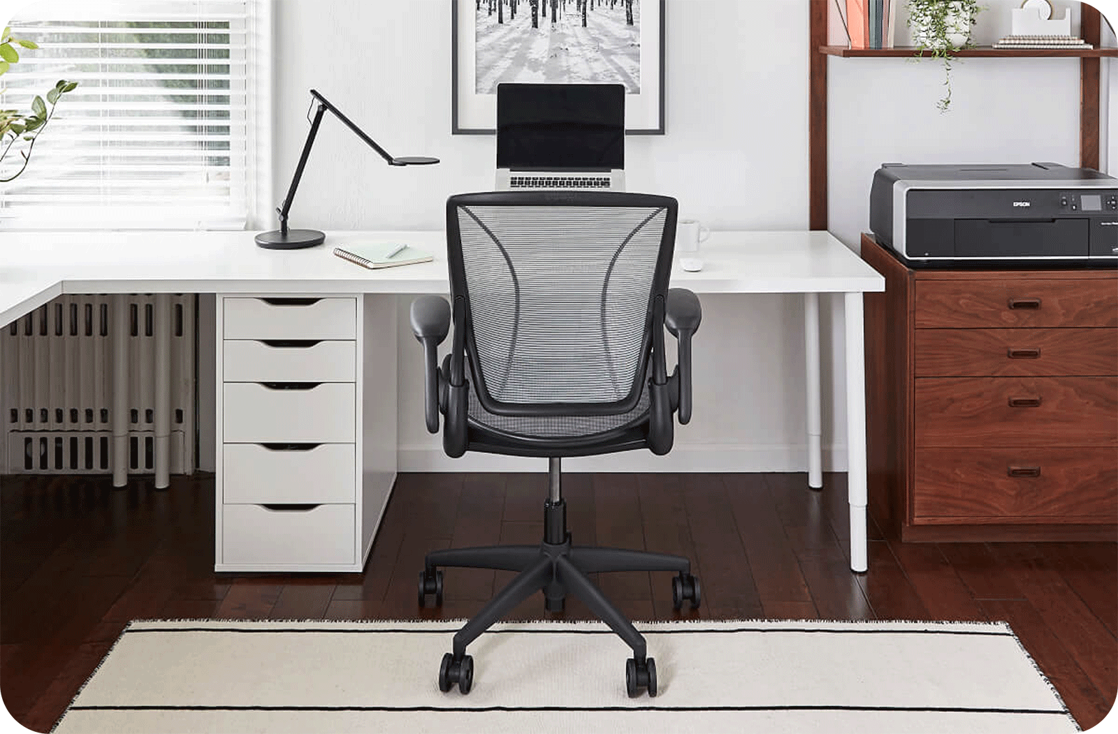modern white desk with black humanscale office chair in a home office