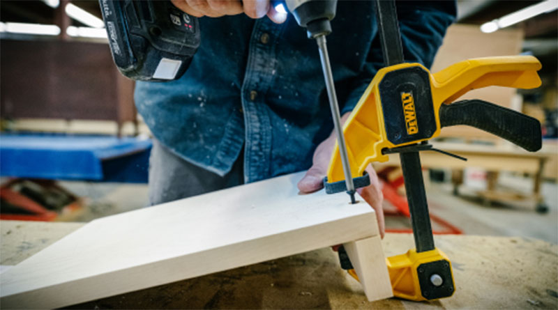 Close-up of a Pompy artisan assembling the desk shelf parts