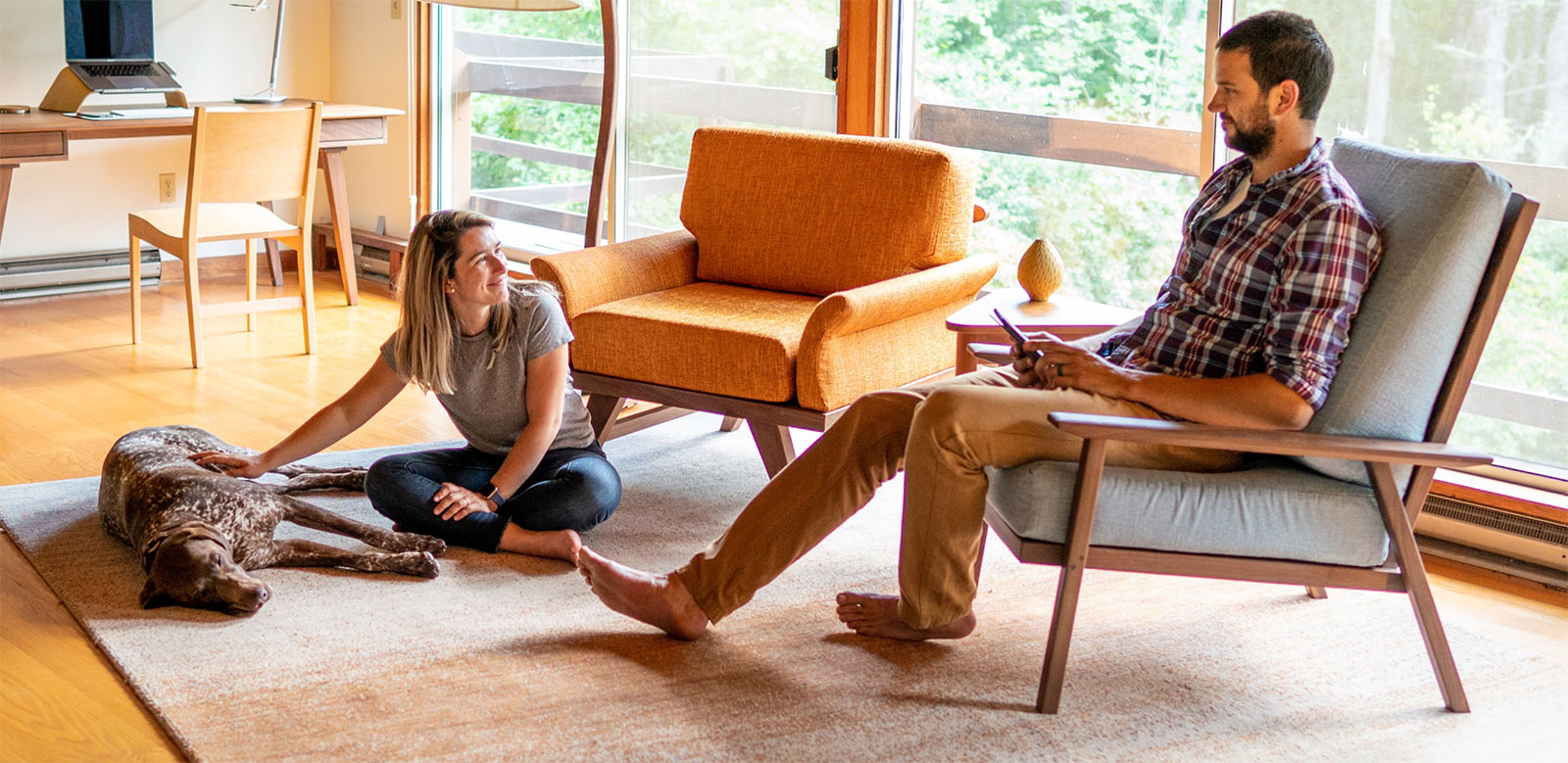 young couple hanging out in their living room with their dog