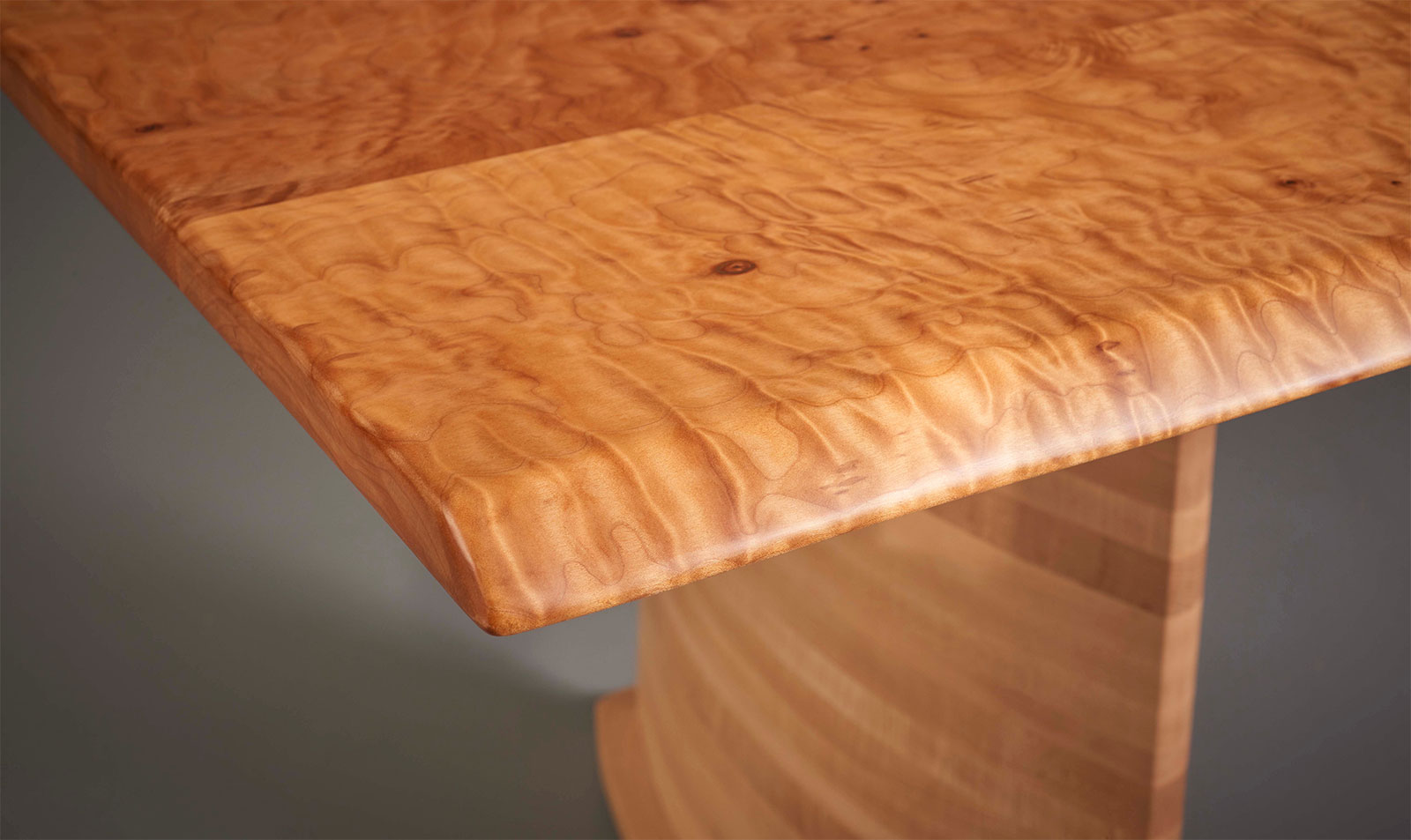 2 modern wood framed westmore chairs in red fabric near a woodstove