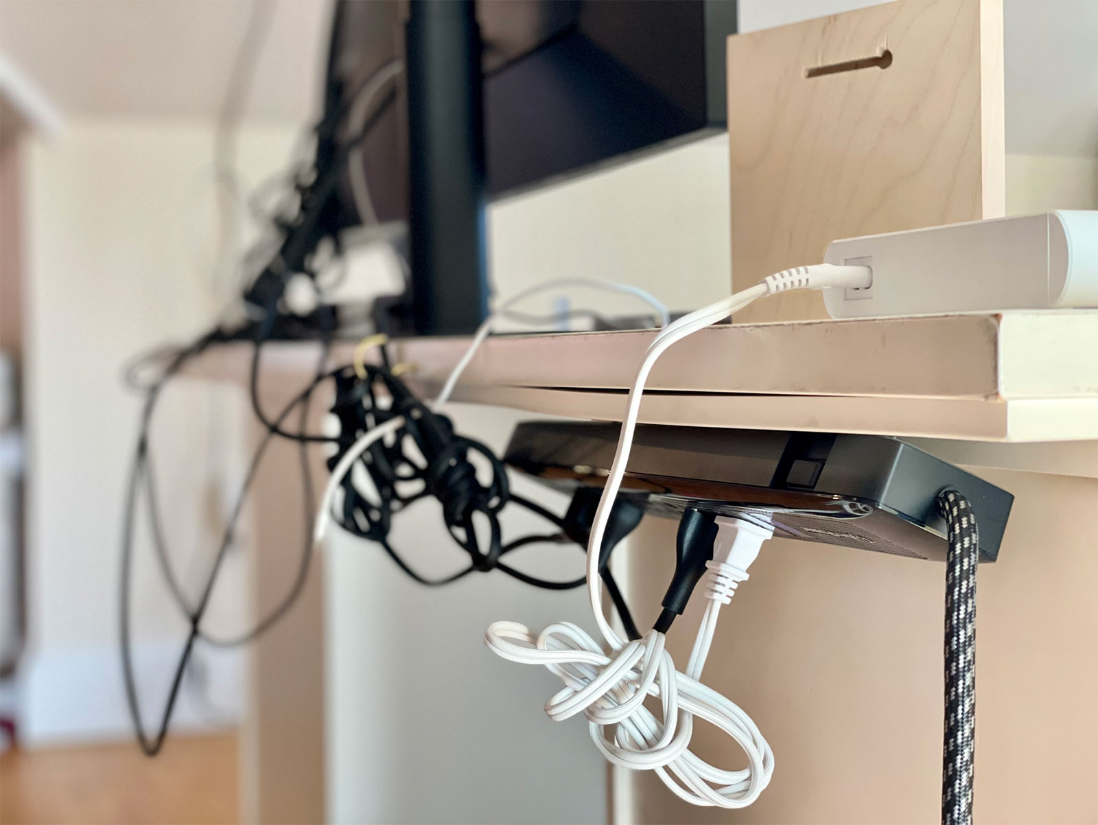 a wire mess behind a desk