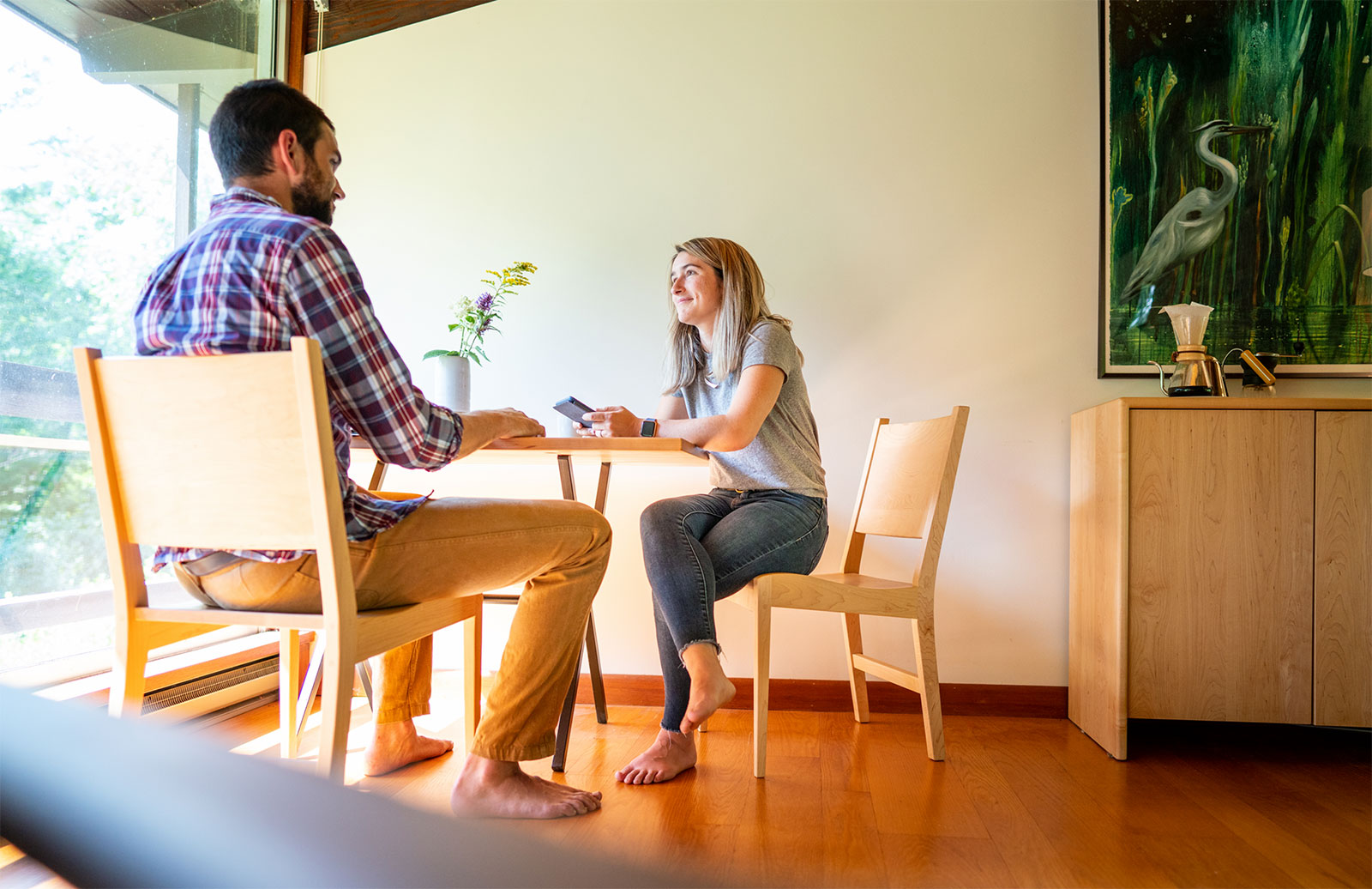 a young couple sitting at small dining table