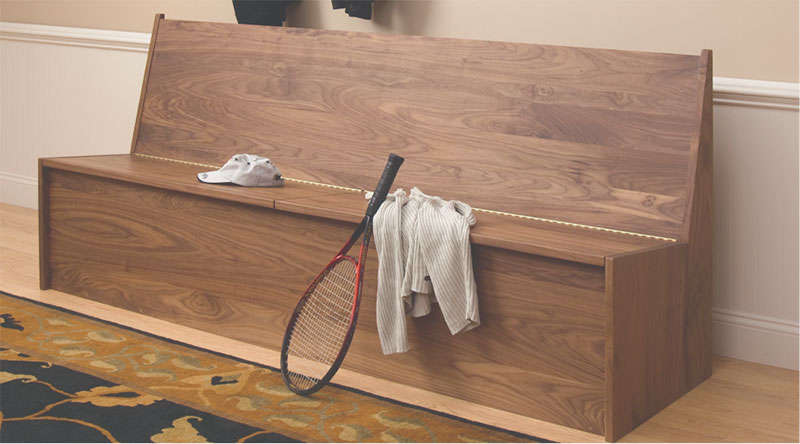 walnut bench with baseball cap and tennis racket