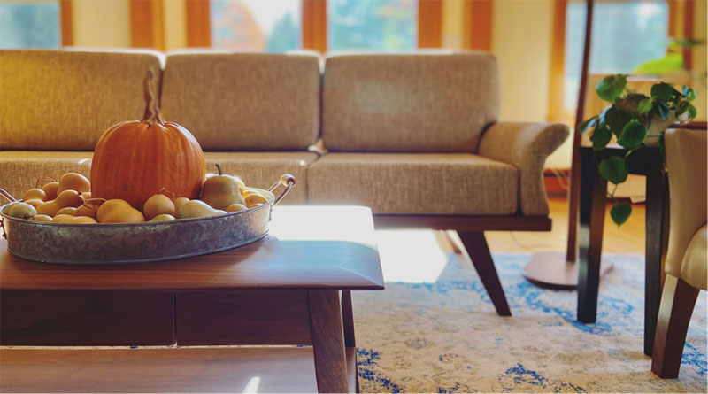 coffe table with pumpkin and couch behind