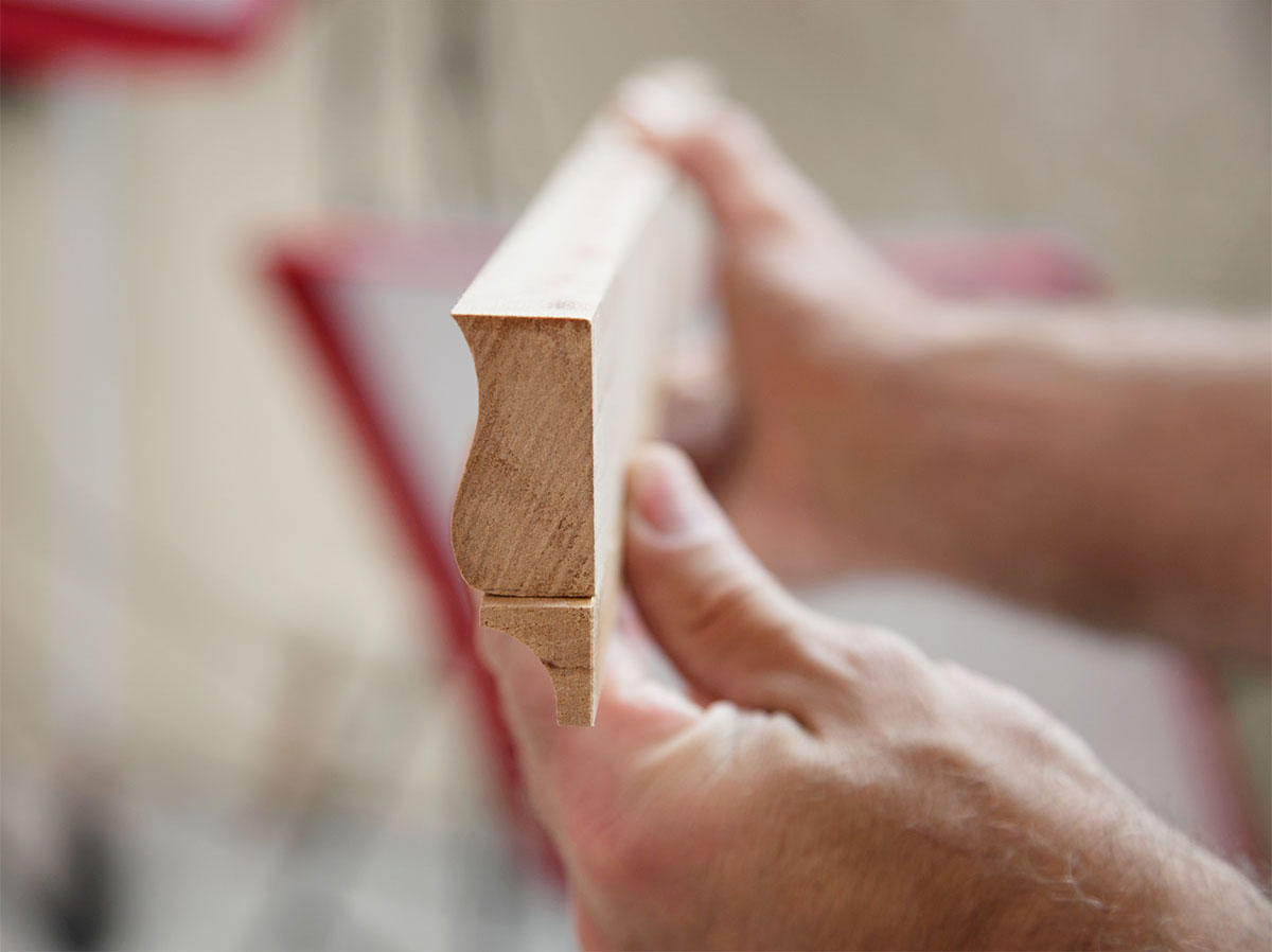 picture of man's hands holding a shaped piece of trim