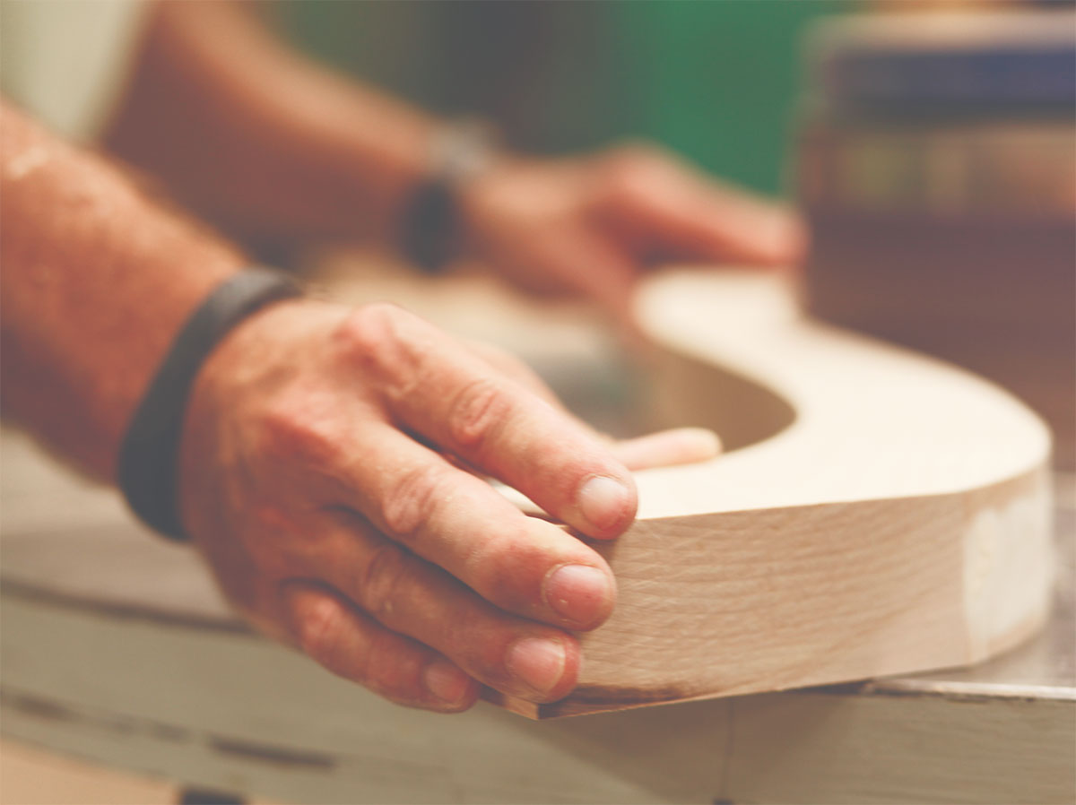 picture of man's hands cutting a curved piece of wood