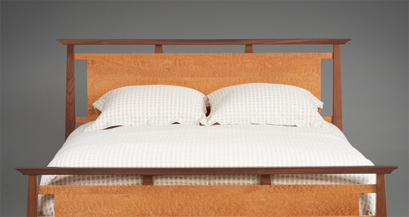 close up of bed with two different wood colors
