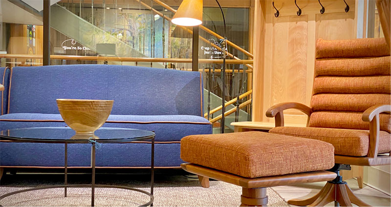 a couch and chair inside of a furniture showroom