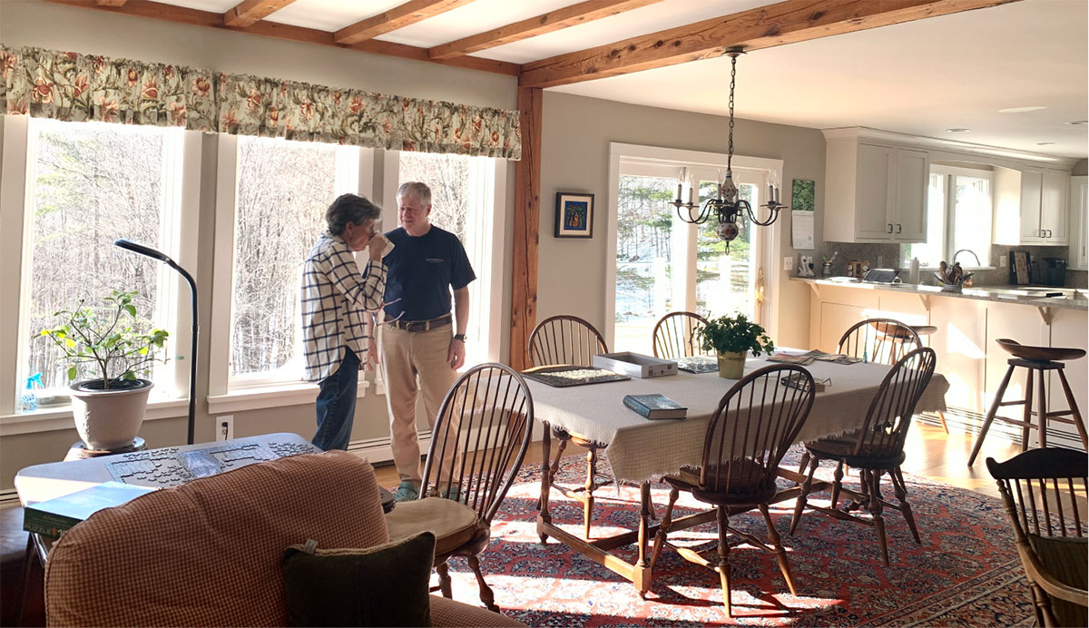 2 guys talking in dining room