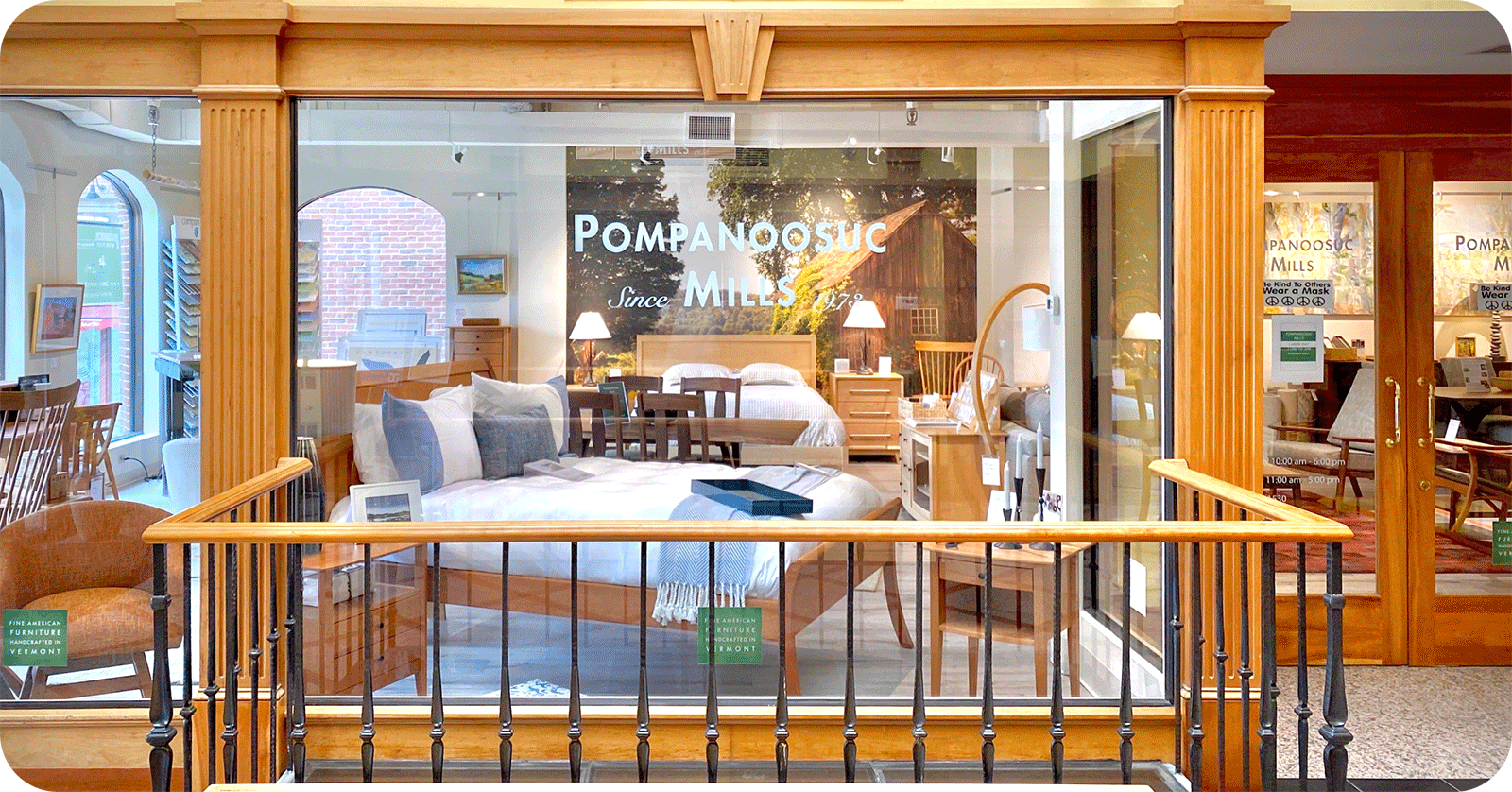 looking through a window into a showroom with a bed in the window