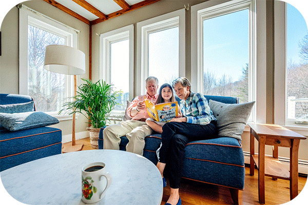 grandparents and child reading a book