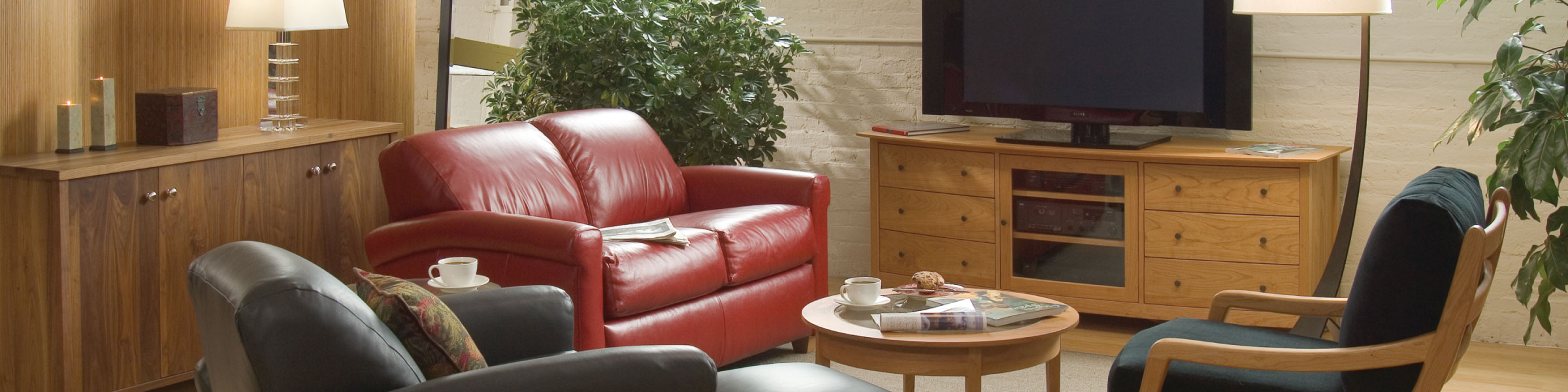 red leather couch in front of entertainment center with TV